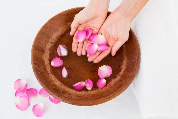 Petals of flower in wooden bowl — Stock Photo, Image