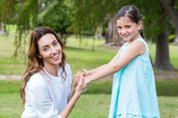Happy mother and daughter smiling at the camera — Stock Photo, Image