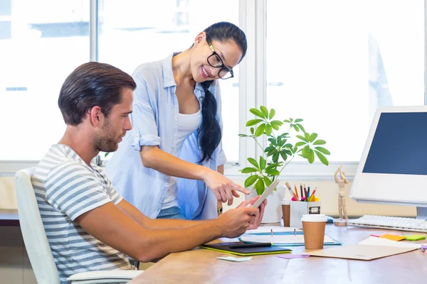 Smiling partners working together on files — Stockfoto