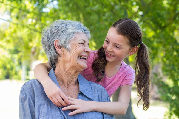 Granddaughter and grandmother smiling — Stockfoto