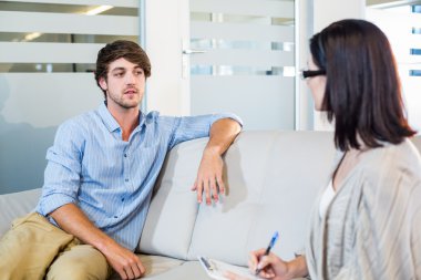 Psychologist talking with depressed man clipart
