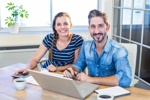 Partners smiling at camera — Stockfoto