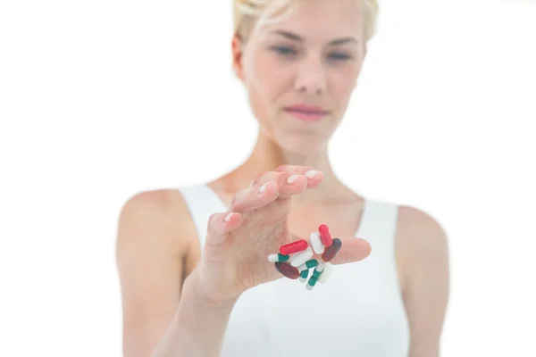 Woman throwing away batch of pills — Stock Photo, Image