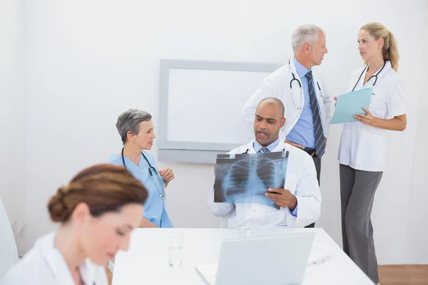 Team of doctors working on their files — Stock Photo, Image