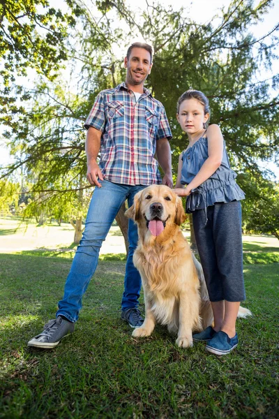 Father and daughter with dog in park — Stock Photo, Image