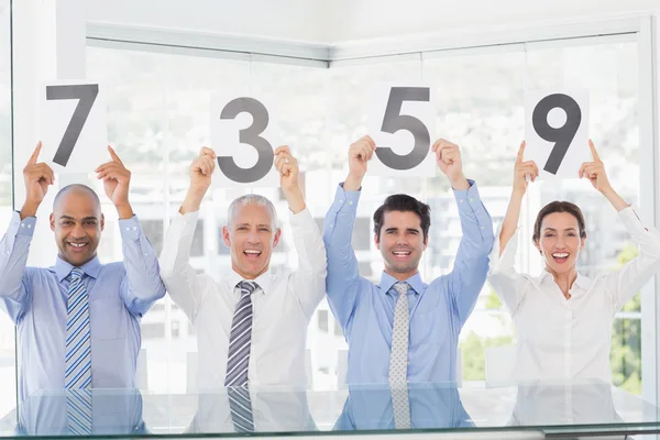 Smiling business team showing paper with rating — Stock Photo, Image