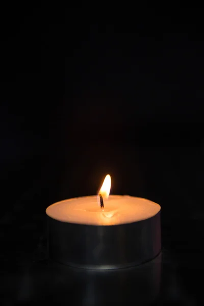 Blazing candle on black — Stock Photo, Image