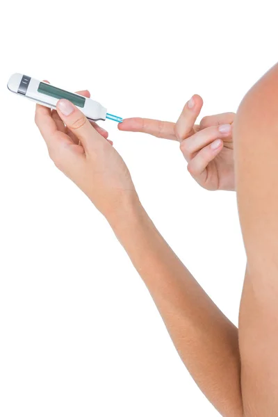 Woman doing test with blood glucose monitor — Stock Photo, Image