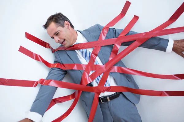 Geschäftsmann in der Bürokratie gefangen — Stockfoto