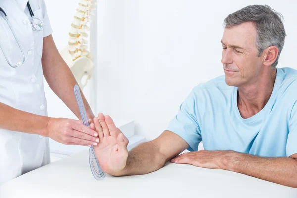 Doctor measuring wrist with goniometer — Stock Photo, Image