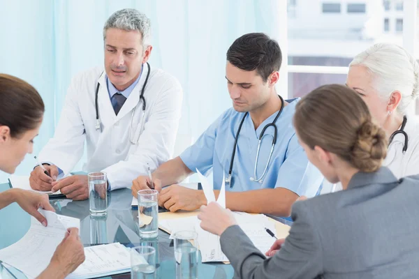 Male and female doctors working on reports — Stock Photo, Image