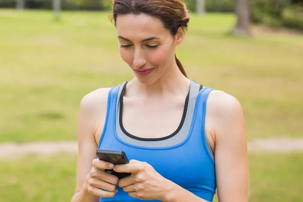 Pretty brunette using smartphone — Stock Photo, Image