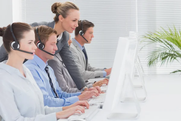 Manager checking the work of staff — Stock Photo, Image