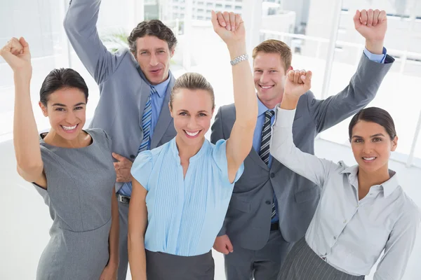 Excited business team cheering at camera — Stock Photo, Image
