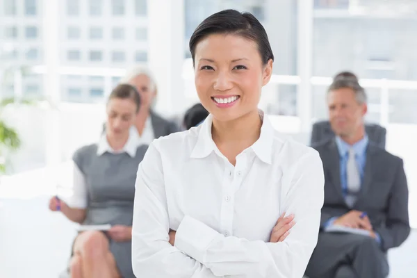 Business people looking at camera with arms crossed — Stock Photo, Image