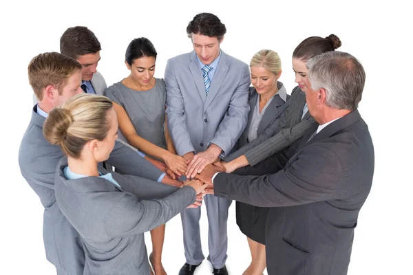 Smiling business team standing in circle hands together Royalty Free Stock Images