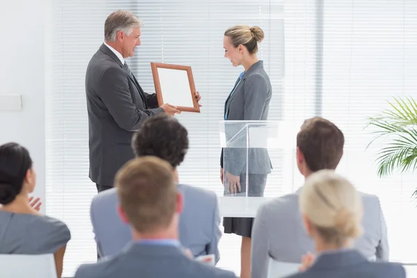 Pretty businesswoman receiving prize — Stock Photo, Image