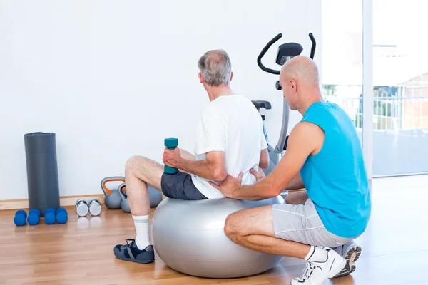 Old man having back massage on exercise ball — Stock Photo, Image