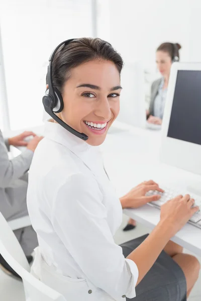 Smiling businesswoman wearing headset — Stock Photo, Image