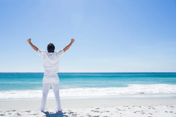 Man stretching his arms in front of the sea — Stock Photo, Image
