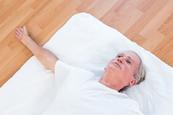 Old man relaxing with open eyes — Stock Photo, Image