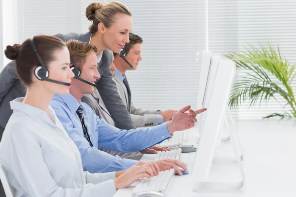 Manager checking the work of staff — Stock Photo, Image