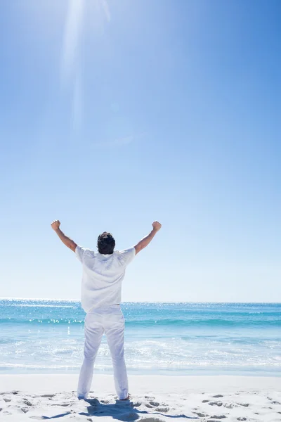 Seorang pria merentangkan tangannya di depan laut — Stok Foto