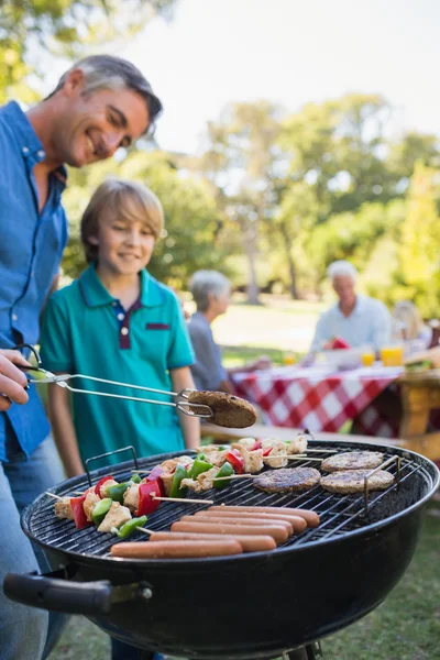 Father doing barbecue with his son — Stock Photo, Image
