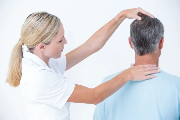 Doctor doing neck adjustment — Stock Photo, Image