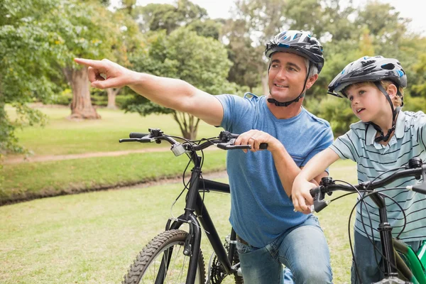 Happy father on a bike with his son — Stock Photo, Image