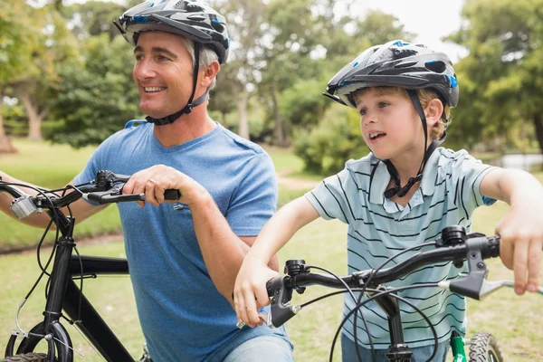 Happy father on a bike with his son — Stock Photo, Image