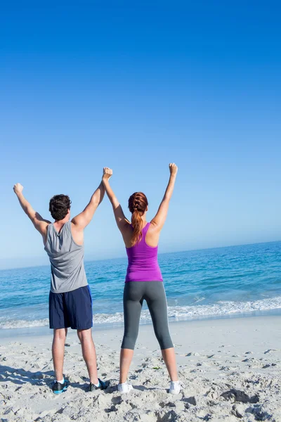 Happy couple raising their hands — Stock Photo, Image