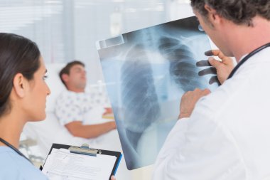 Doctors checking patients xray clipart