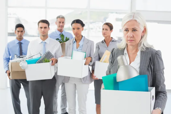 Unhappy fired business people holding box — Stock Photo, Image