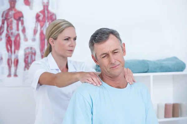 Doctor stretching her patient neck — Stock Photo, Image