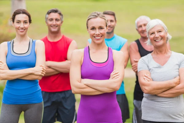 Happy athletic group smiling at camera with hands crossed — Stock Photo, Image