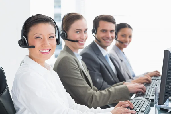 Business people with headsets using computers — Stock Photo, Image