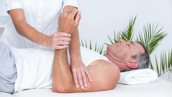 Doctor examining her patient arm — Stock Photo, Image