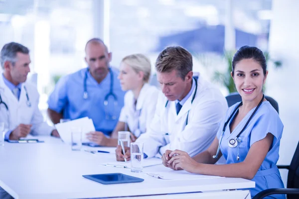 Nurse smiling at camera during meeting — Stock Photo, Image