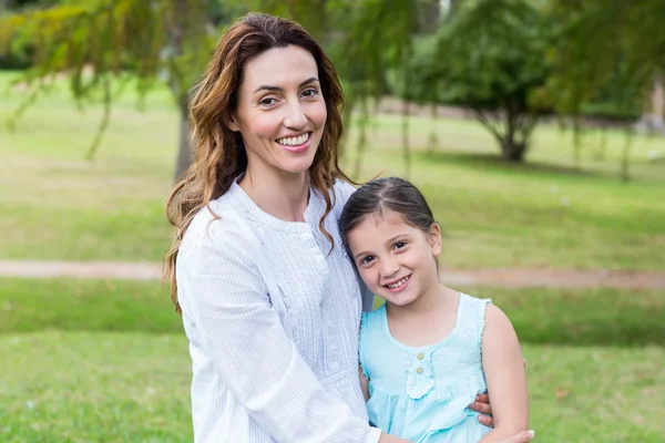 Happy mother and daughter smiling at the camera — Stok fotoğraf