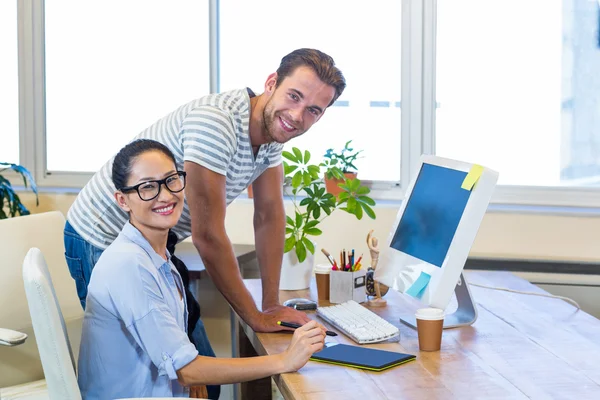 Smiling partners working together on computer — Stock Photo, Image