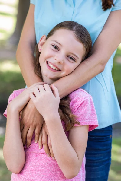 Happy mother and daughter smiling at the camera — Stockfoto