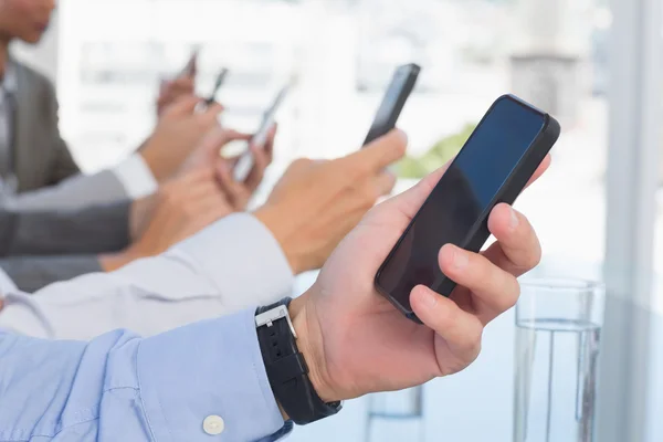 Zakelijke team met behulp van hun mobiele telefoon — Stockfoto