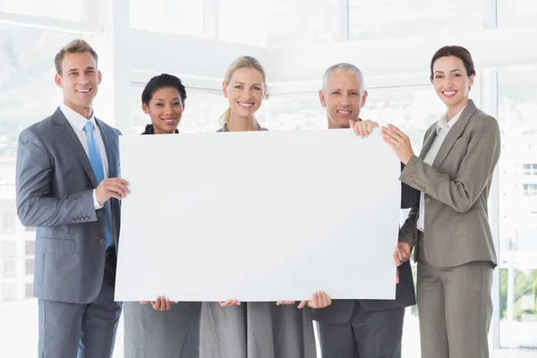 Business colleagues holding poster together — Stock Photo, Image