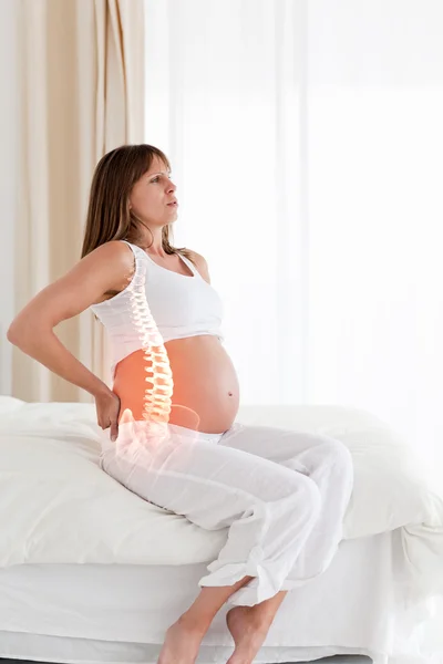 Highlighted spine of pregnant woman — Stock fotografie