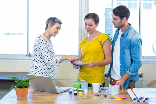 Casual business team discussing about colour chart — Stock Photo, Image