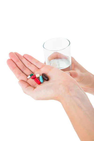 Woman holding batch of pills — Stock Photo, Image