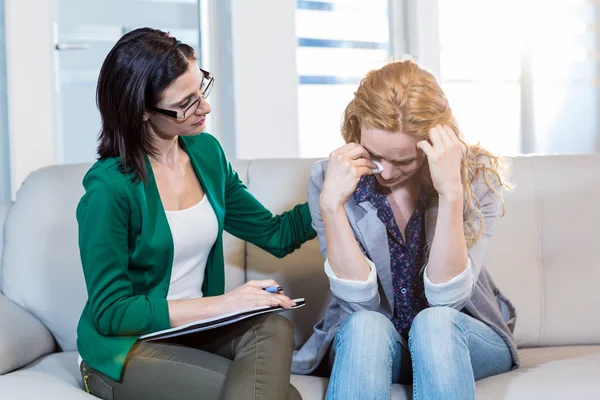 Psychologist comforting a depressed patient — Stockfoto