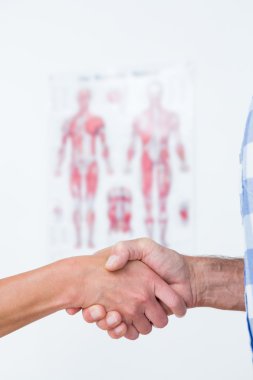 Patient shaking hands with doctor clipart