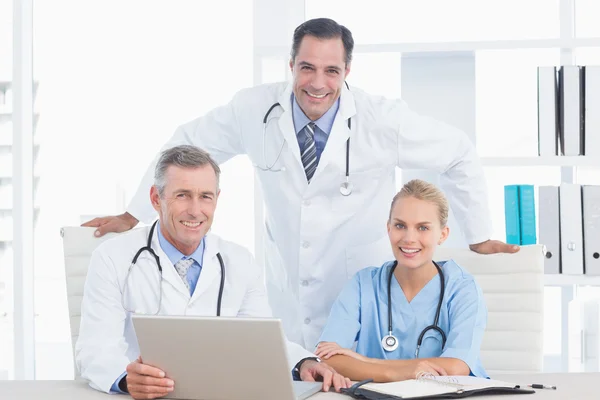 Smiling doctors and nurse — Stock Photo, Image